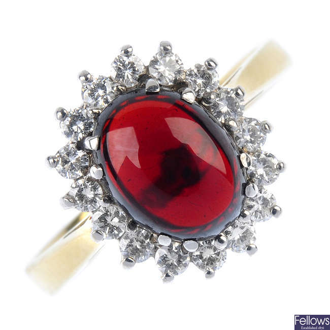 An 18ct gold garnet and diamond cluster ring. 