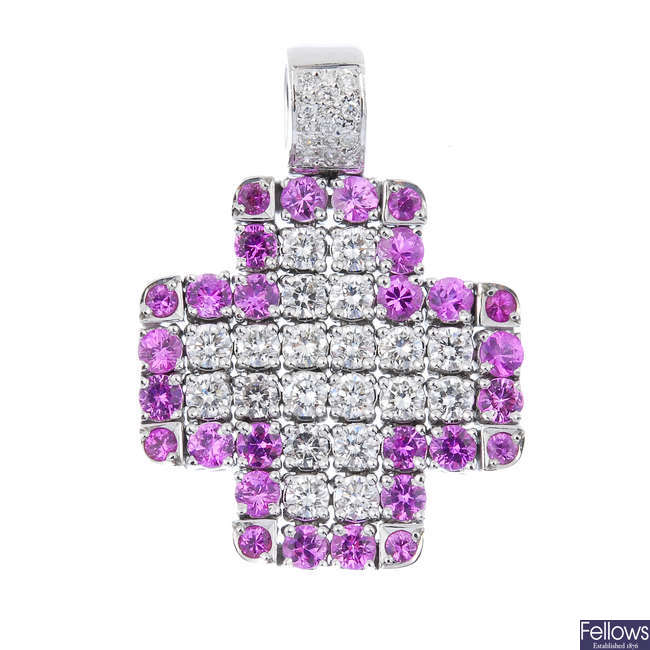A diamond and sapphire articulated cross pendant.
