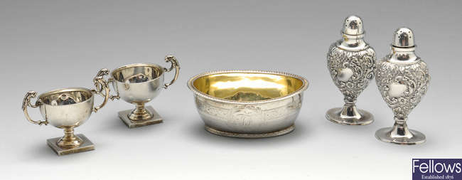 A Georgian silver open salt, pair of Victorian peppers & a later pair of miniature trophy cups.