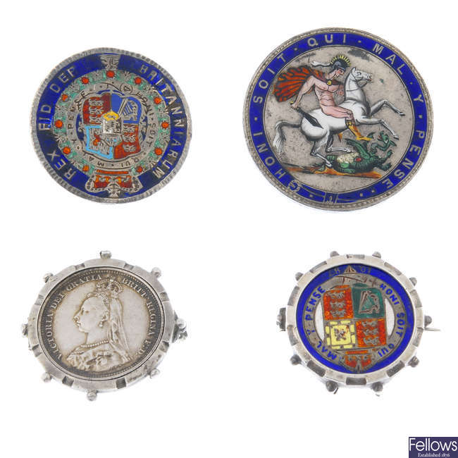 A selection of coin brooches.