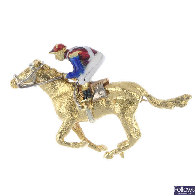 An 18ct gold enamel horse and jockey brooch.