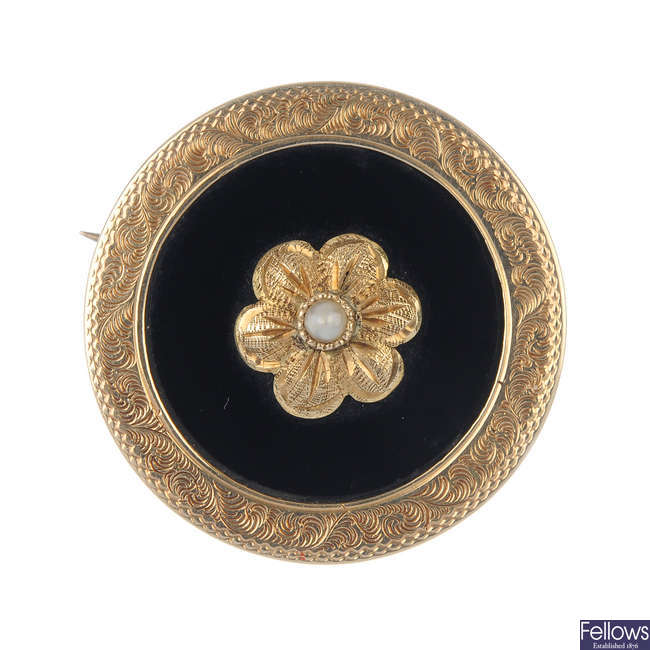 A late 19th century gold seed pearl and onyx memorial brooch.