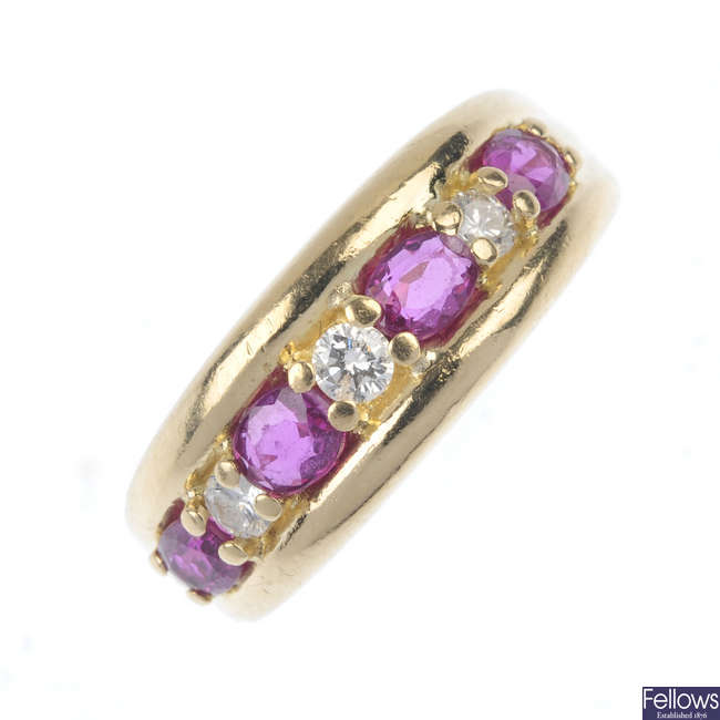 An 18ct gold ruby and diamond seven-stone ring.