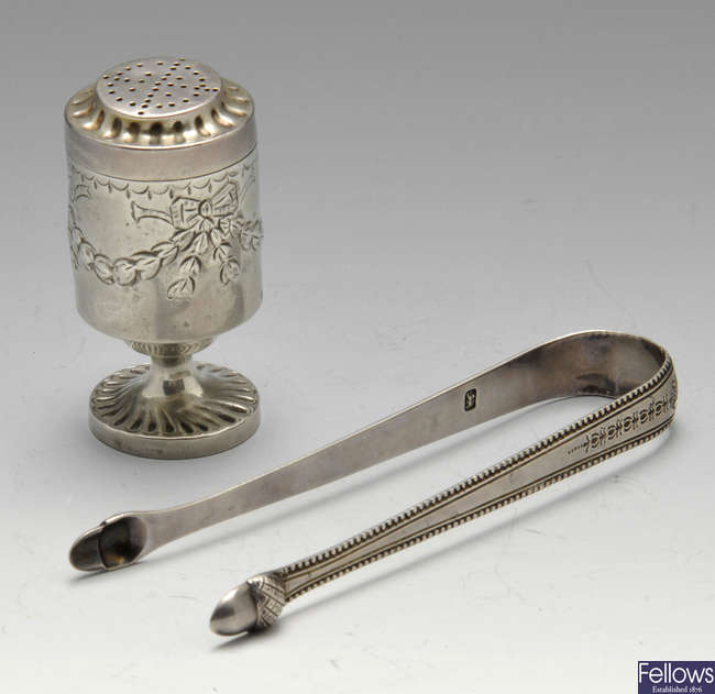 A George III pepperette, sugar tongs, sifter spoon, etc.