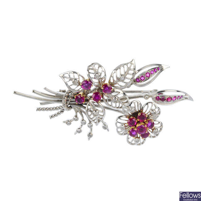 A diamond and ruby floral brooch.