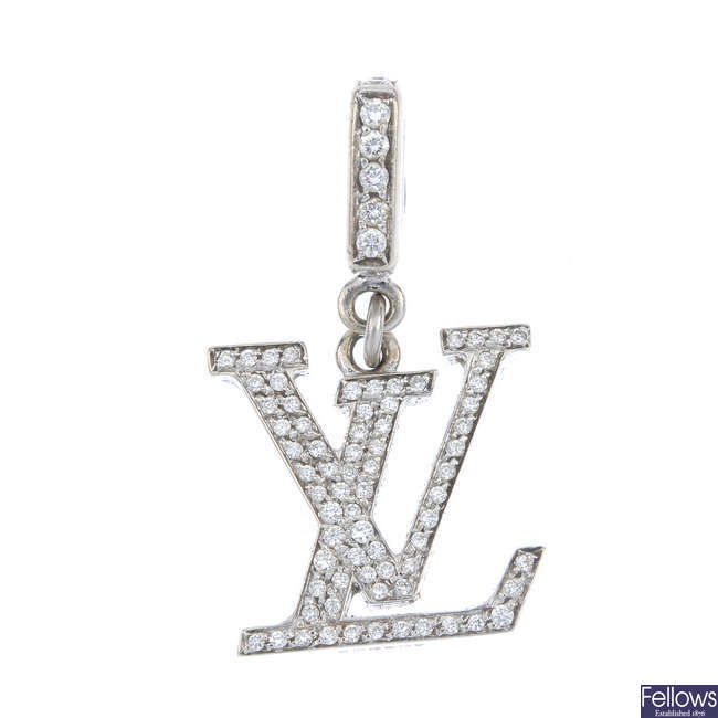 LOT:348 | LOUIS VUITTON - a diamond 'LV' pendant.