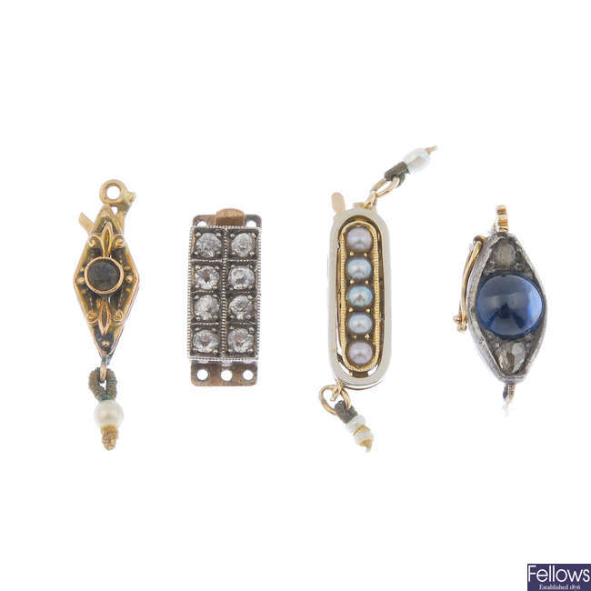 Four early to mid 20th century gem necklace clasps and a safety chain.
