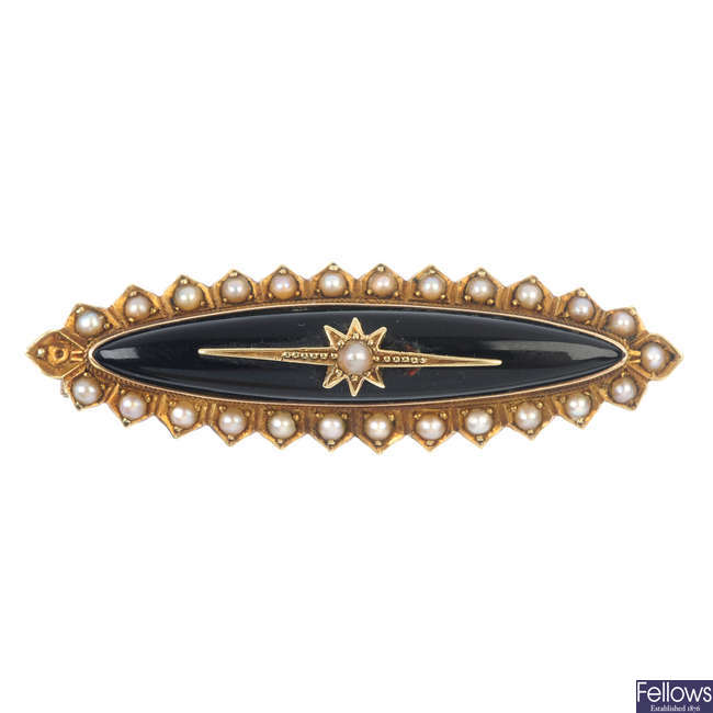 A late Victorian gold onyx and seed pearl memorial brooch.