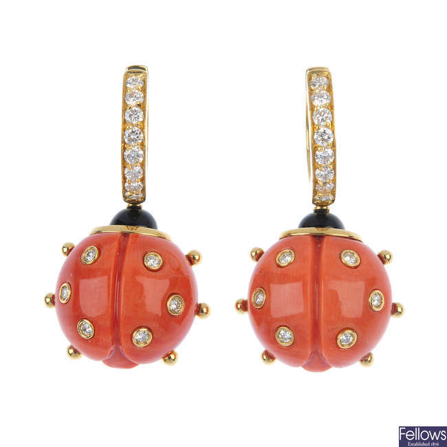 A pair of coral, diamond and onyx ladybird ear pendants.