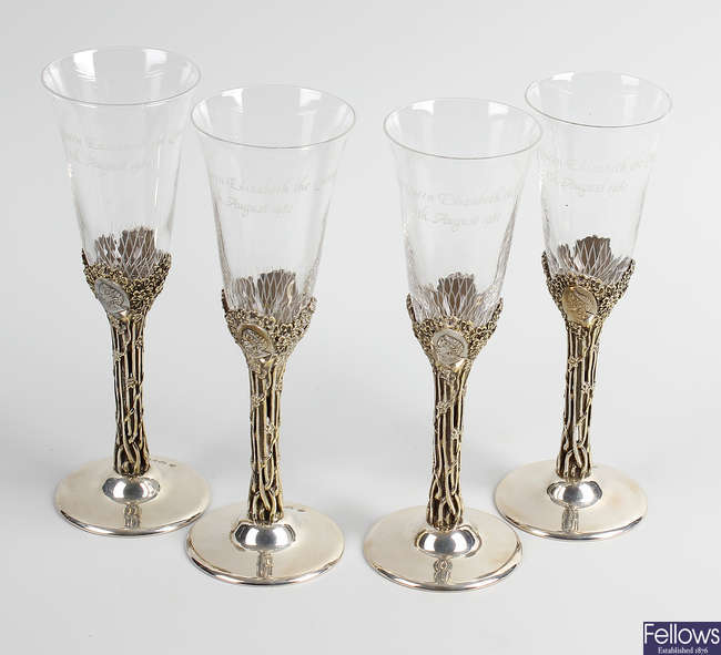 A set of four silver mounted commemorative glasses. 