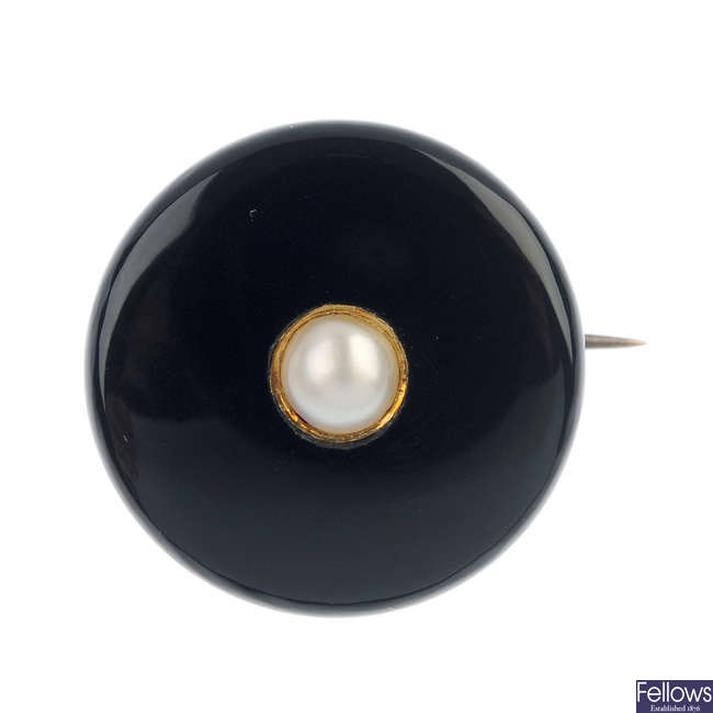 A late 19th century gold onyx and split pearl memorial brooch.
