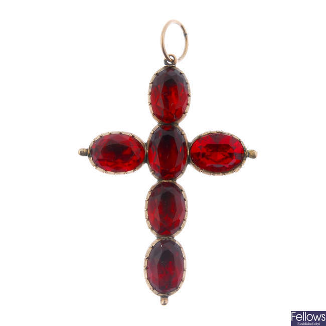 A mid 19th century red paste cross pendant.