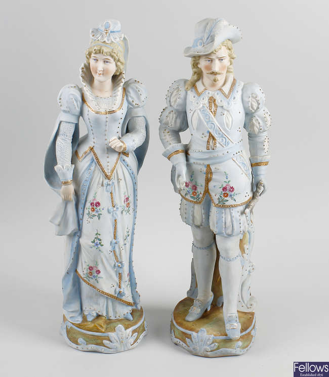  A pair of late 19th century tinted bisque porcelain figures. 