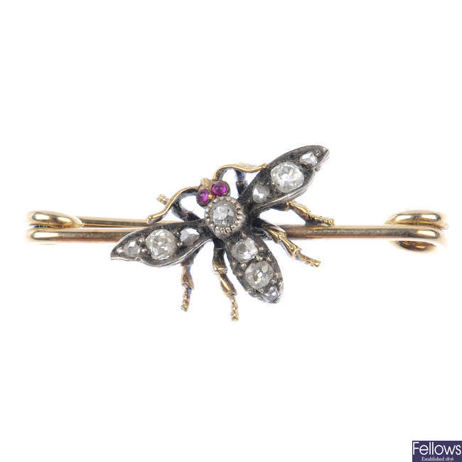 A diamond and ruby insect brooch.
