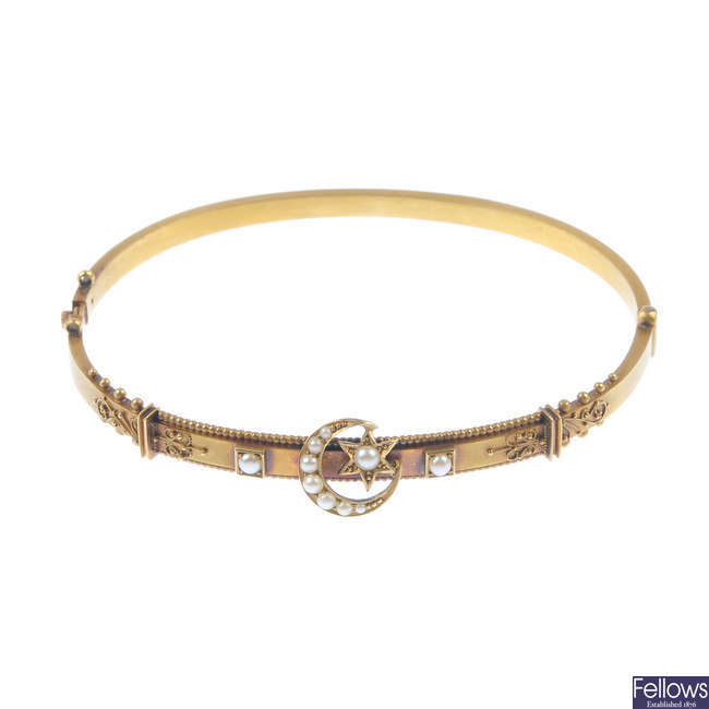 An early 20th century gold and split pearl bangle.