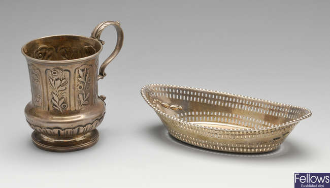 A George IV christening mug, Edwardian dish & a claret jug mount. (3).