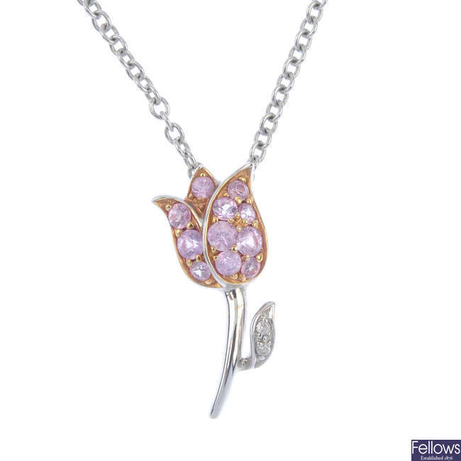 A sapphire and diamond floral pendant.