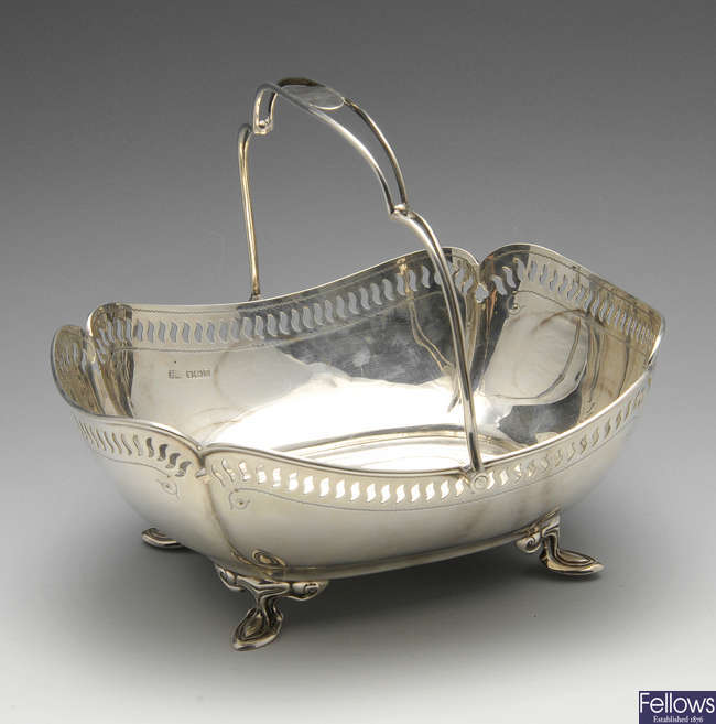 A George V silver swing handled pierced basket. 