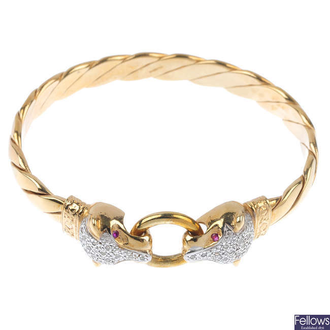 A 9ct gold diamond and gem-set panther bangle.
