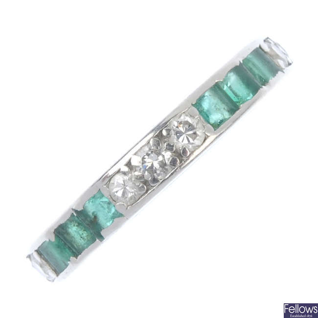A mid 20th century platinum emerald and diamond full-circle eternity ring.