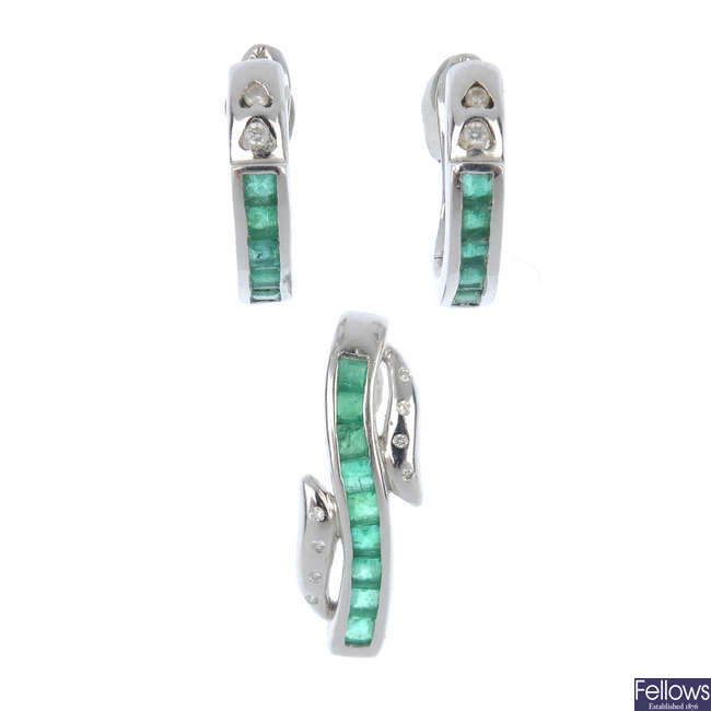 An emerald and diamond pendant and earring set.