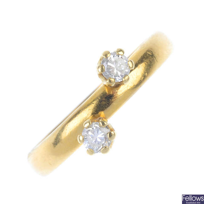 A 22ct gold diamond two-stone ring. 
