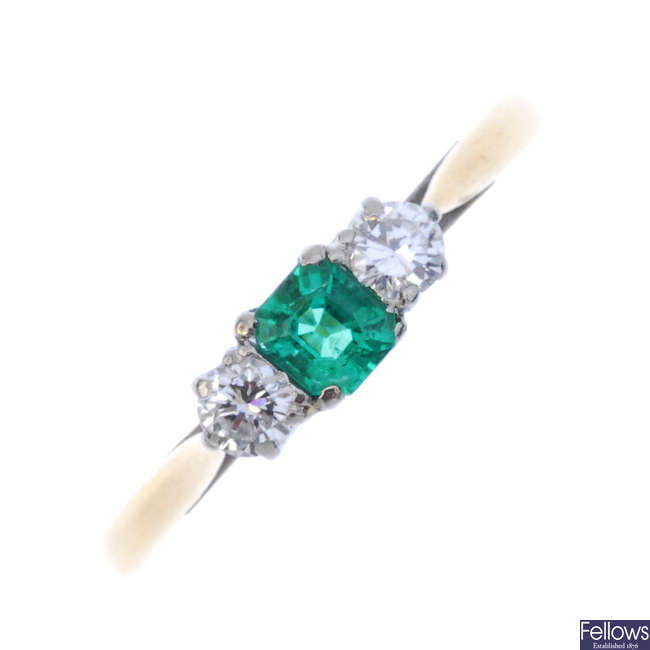 A mid 20th century 18ct gold emerald and diamond three-stone ring.