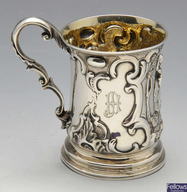 A Victorian silver embossed mug.