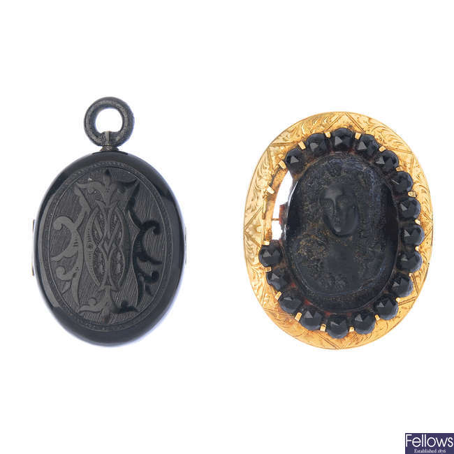 A late Victorian jet locket and a lava brooch.