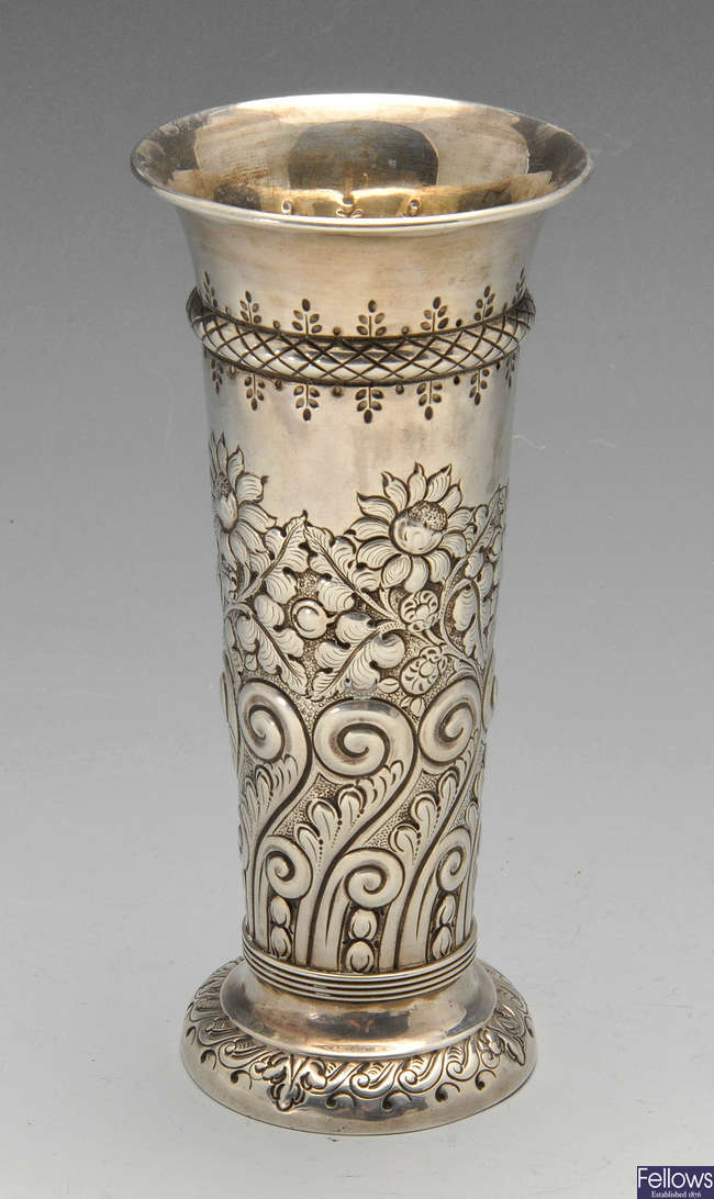 A late Victorian embossed silver vase.