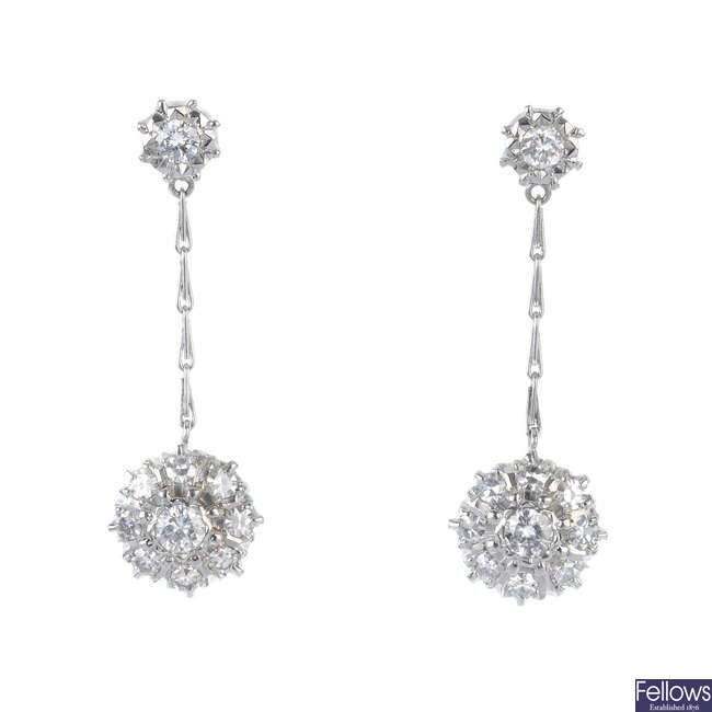 A pair of diamond cluster ear pendants.