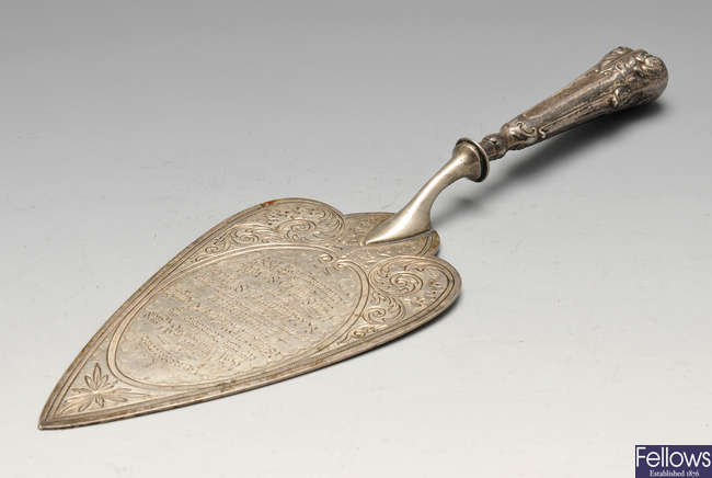 A late Victorian silver presentation trowel, plus another plated example. 