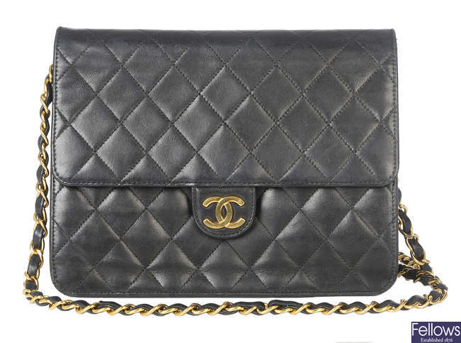 CHANEL - a black quilted leather handbag.