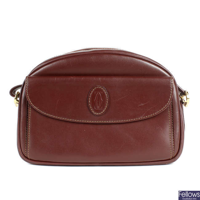 CARTIER - a Bordeaux leather crossbody handbag.
