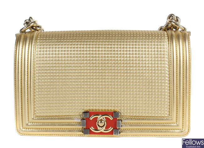 CHANEL - a metallic gold Cube Boy flap handbag.