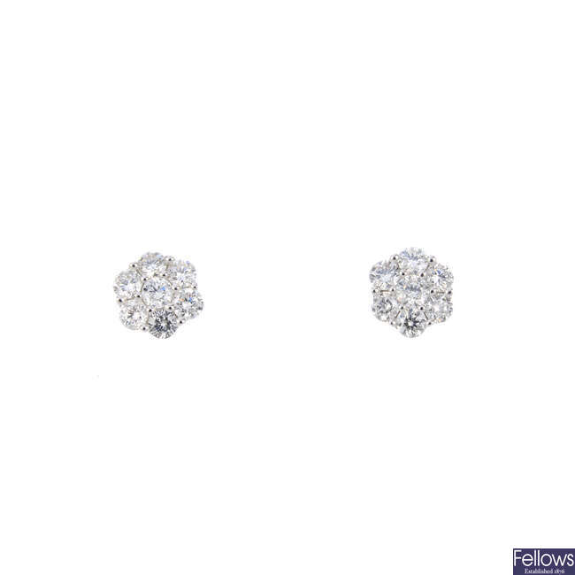 A pair of diamond floral cluster stud earrings.