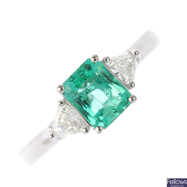 A platinum Colombian emerald and diamond three-stone ring.