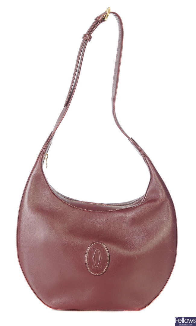 CARTIER - a Bordeaux leather hobo handbag.