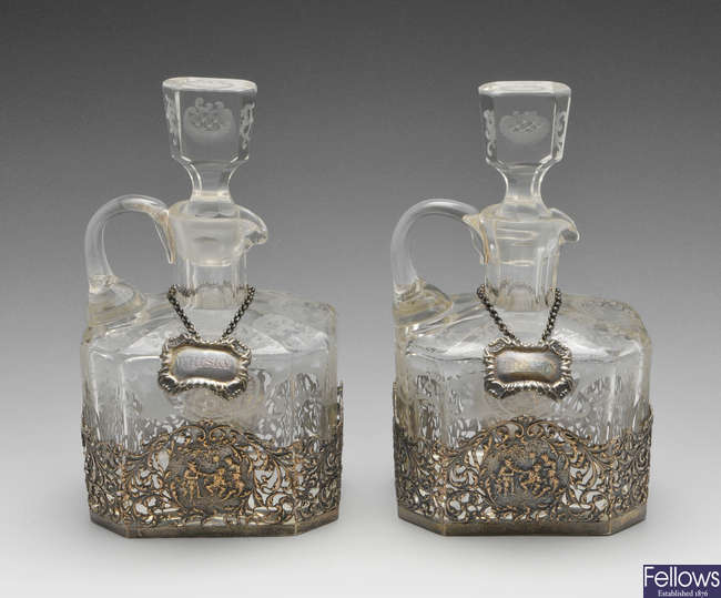 A pair of 1920's silver mounted cut-glass decanters.