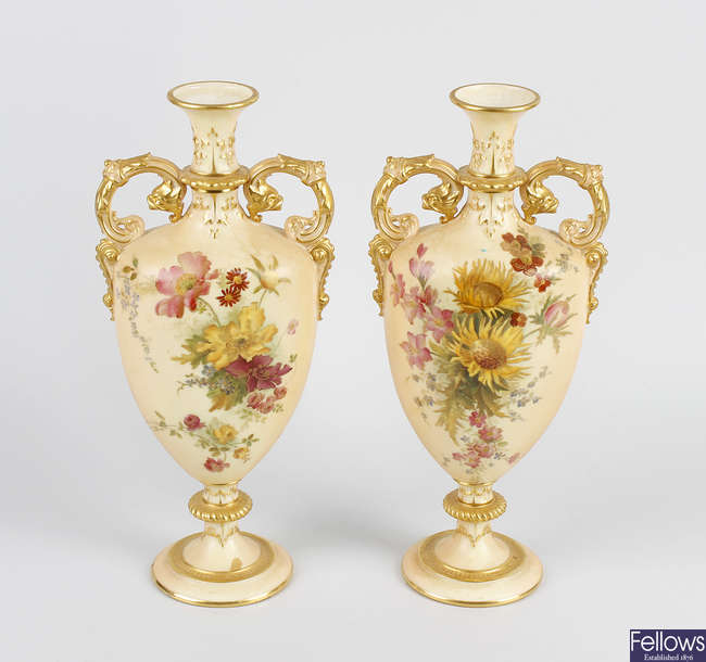 A pair of Royal Worcester porcelain blush ivory twin handled vases.