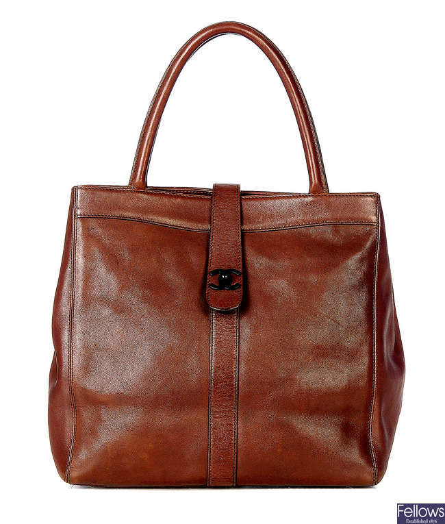 CHANEL - a brown leather handbag.