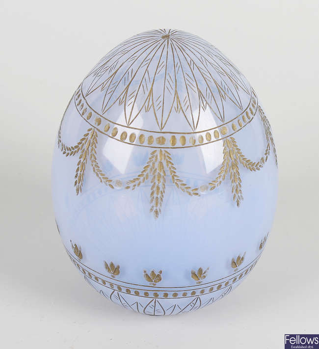 A light blue glass egg, in the manner of Faberge.