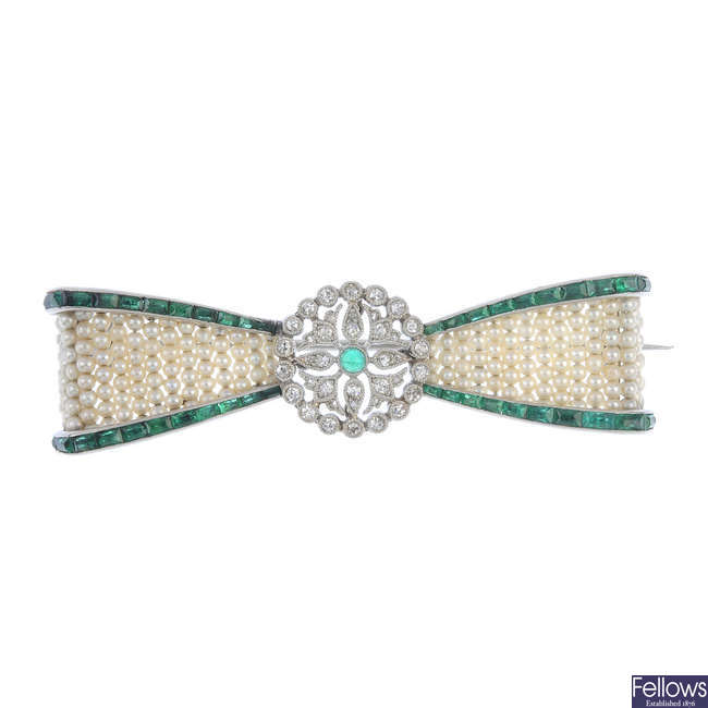 A Belle Epoque 18ct gold emerald, diamond and seed pearl bow brooch.