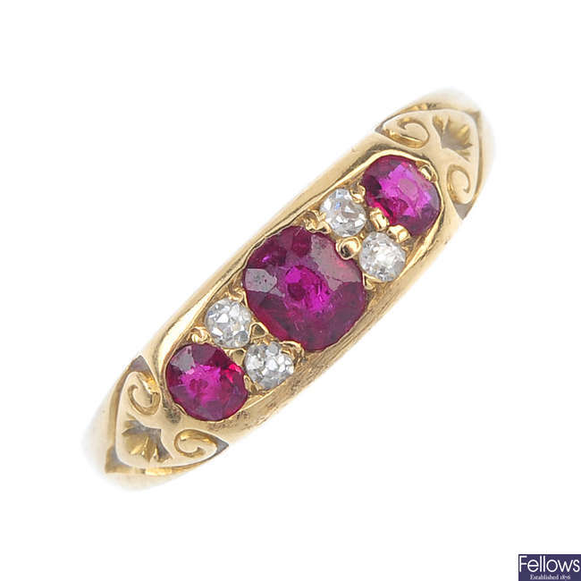 An early 20th century 18ct gold ruby three-stone and diamond ring.