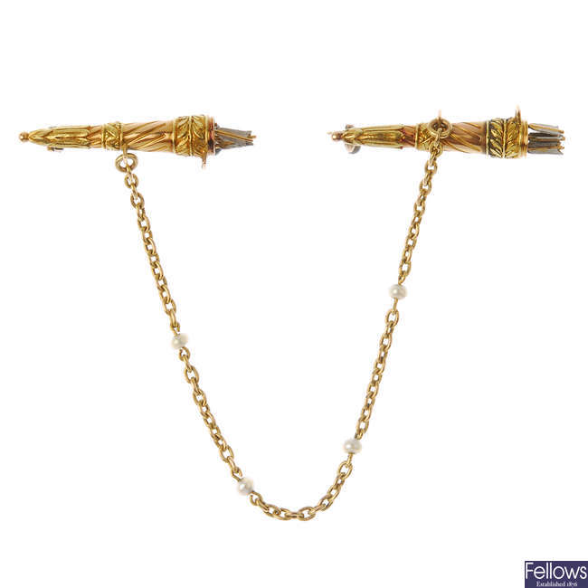A late 19th century gold bow and arrow cloak fastener.