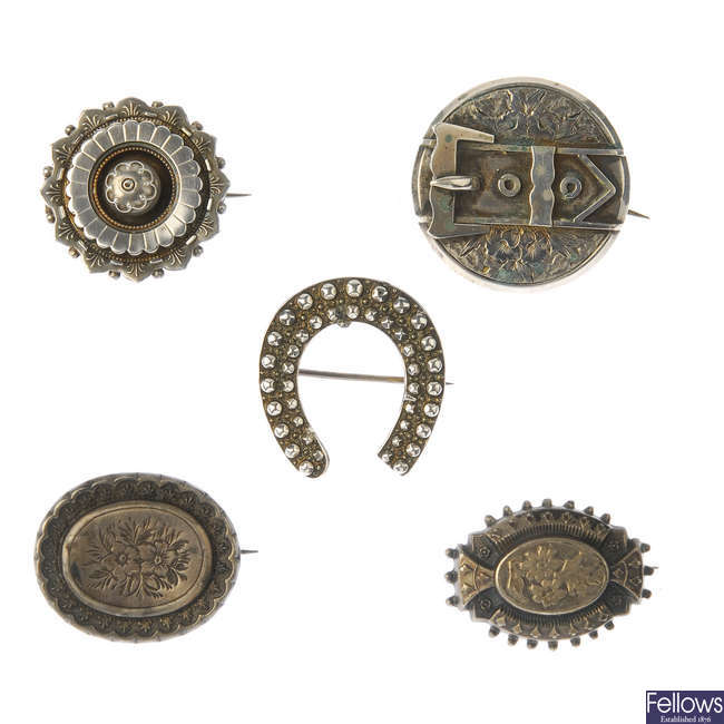 Fifteen late 19th to early 20th century silver brooches.