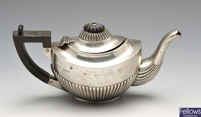 An Edwardian silver bachelor teapot, plus two silver mounted glass scent bottles.