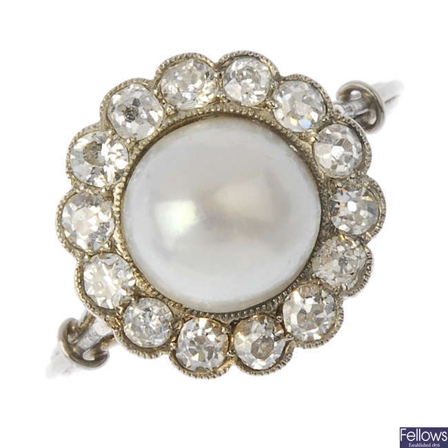 An early 20th century platinum split pearl and diamond cluster ring.