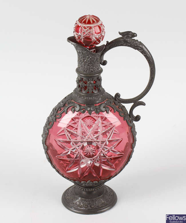 A 19th century pewter mounted cranberry glass decanter.