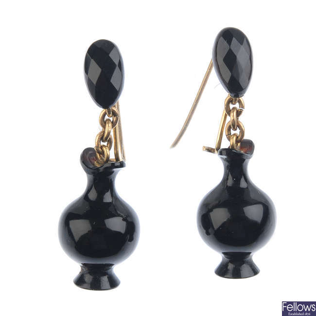 A pair of late 19th century carved onyx urn earrings.